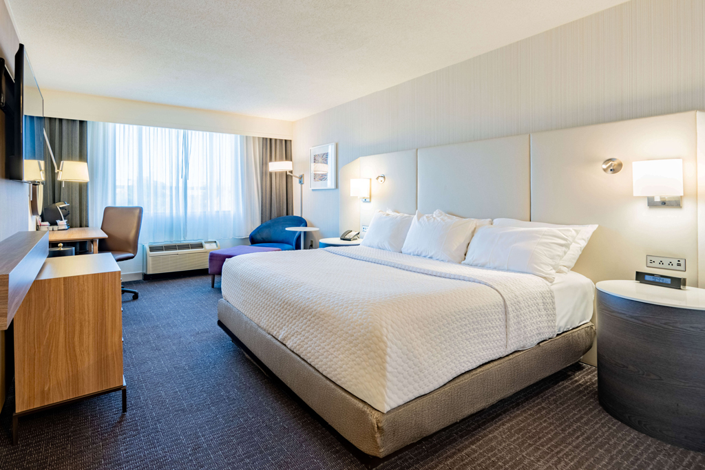 Bright king hotel room with desk and seating