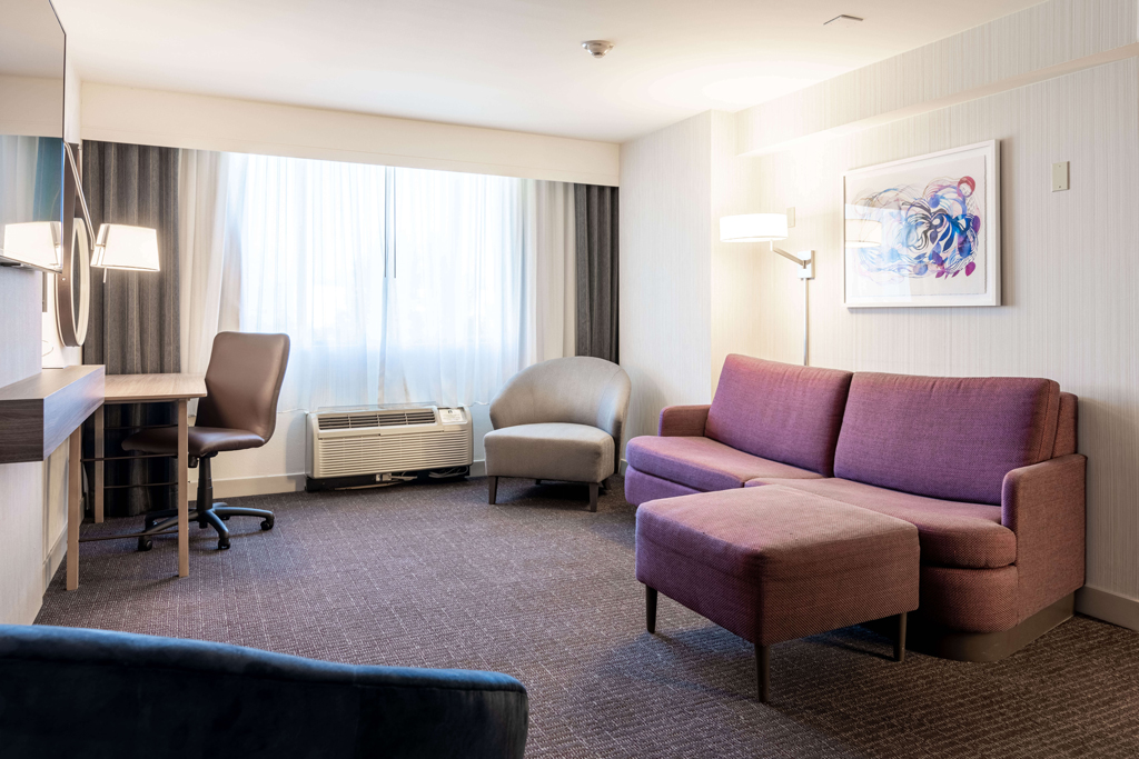 Hotel suite living room with sofa and chairs