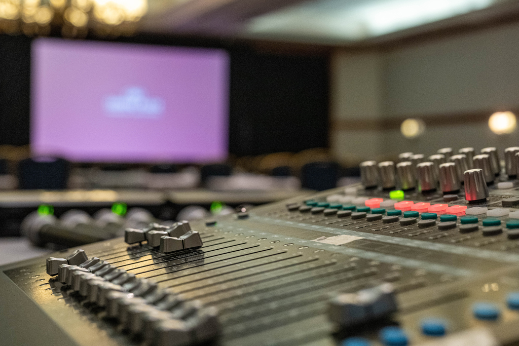 Small meeting room with rows of chairs facing a screen