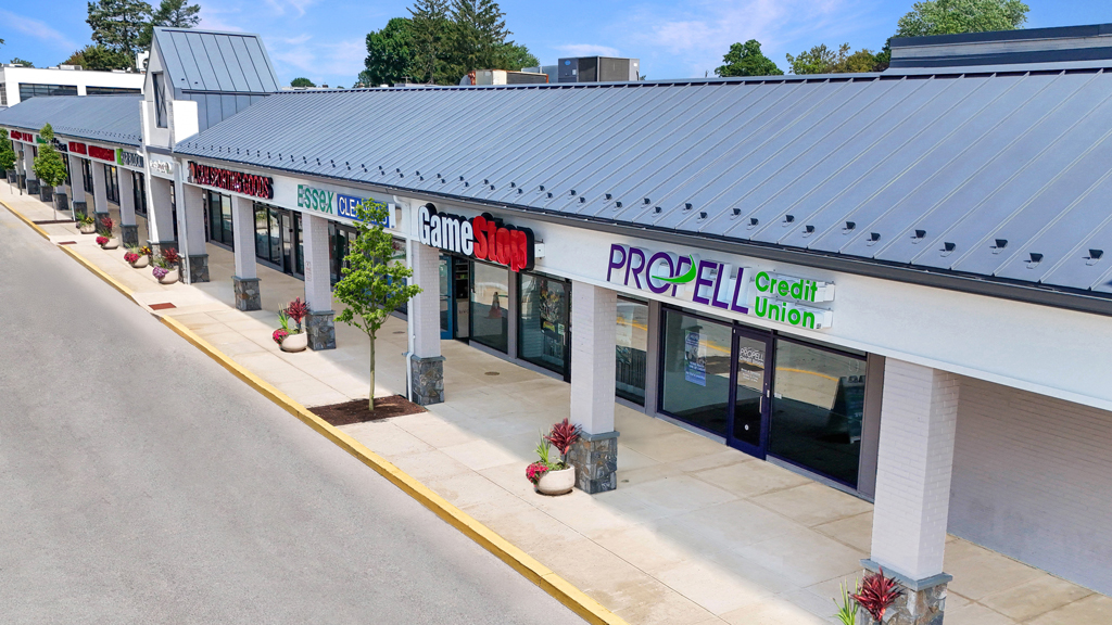 Strip mall with multiple storefronts and sidewalk